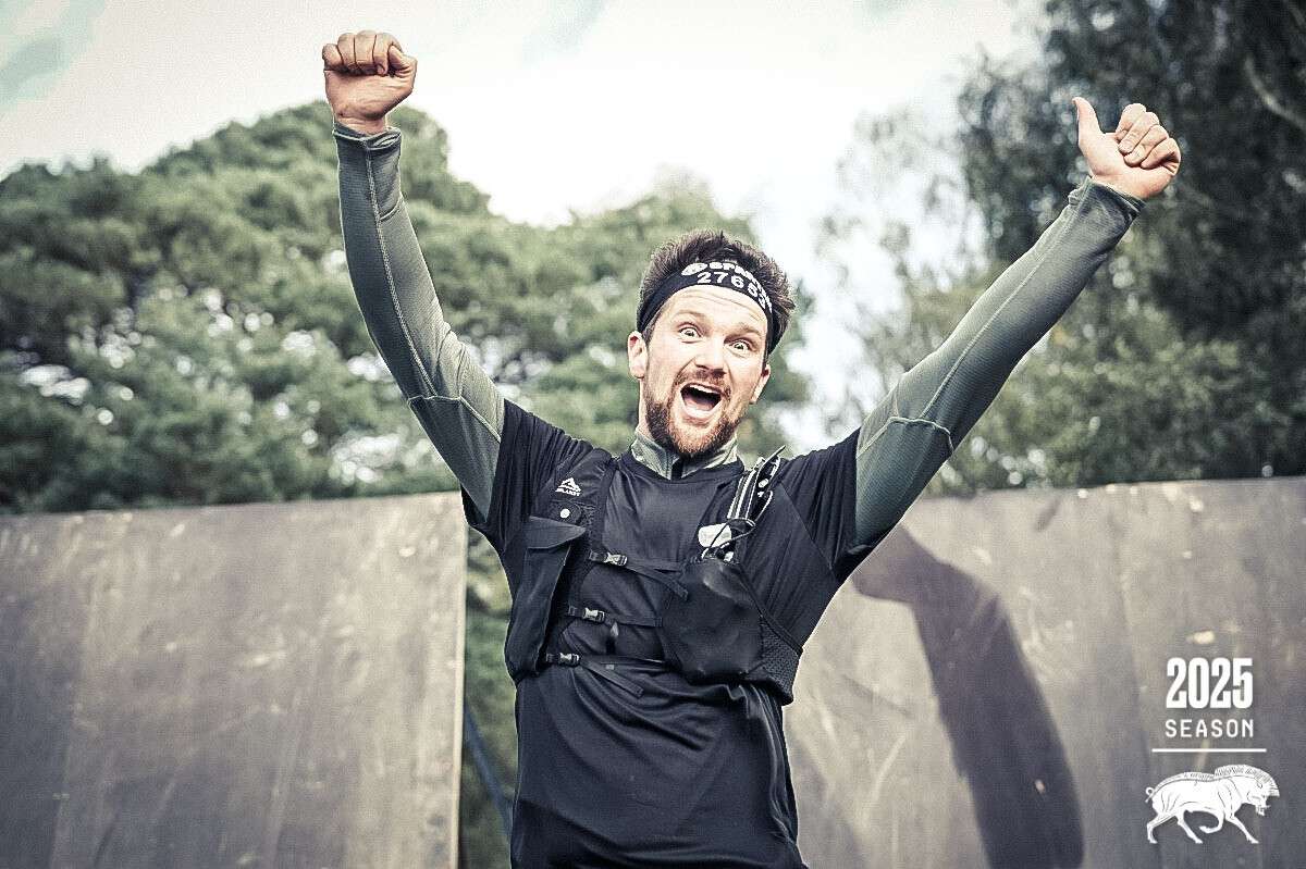Our founder celebrating at the finish line of the Spartan Race at Pippingford Park